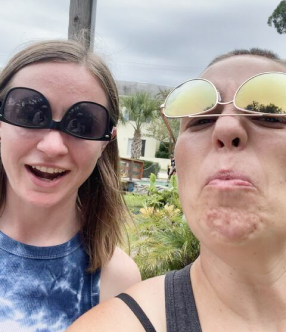Two Flagrant team members are making silly faces, wearing sunglasses upside-down on their face.