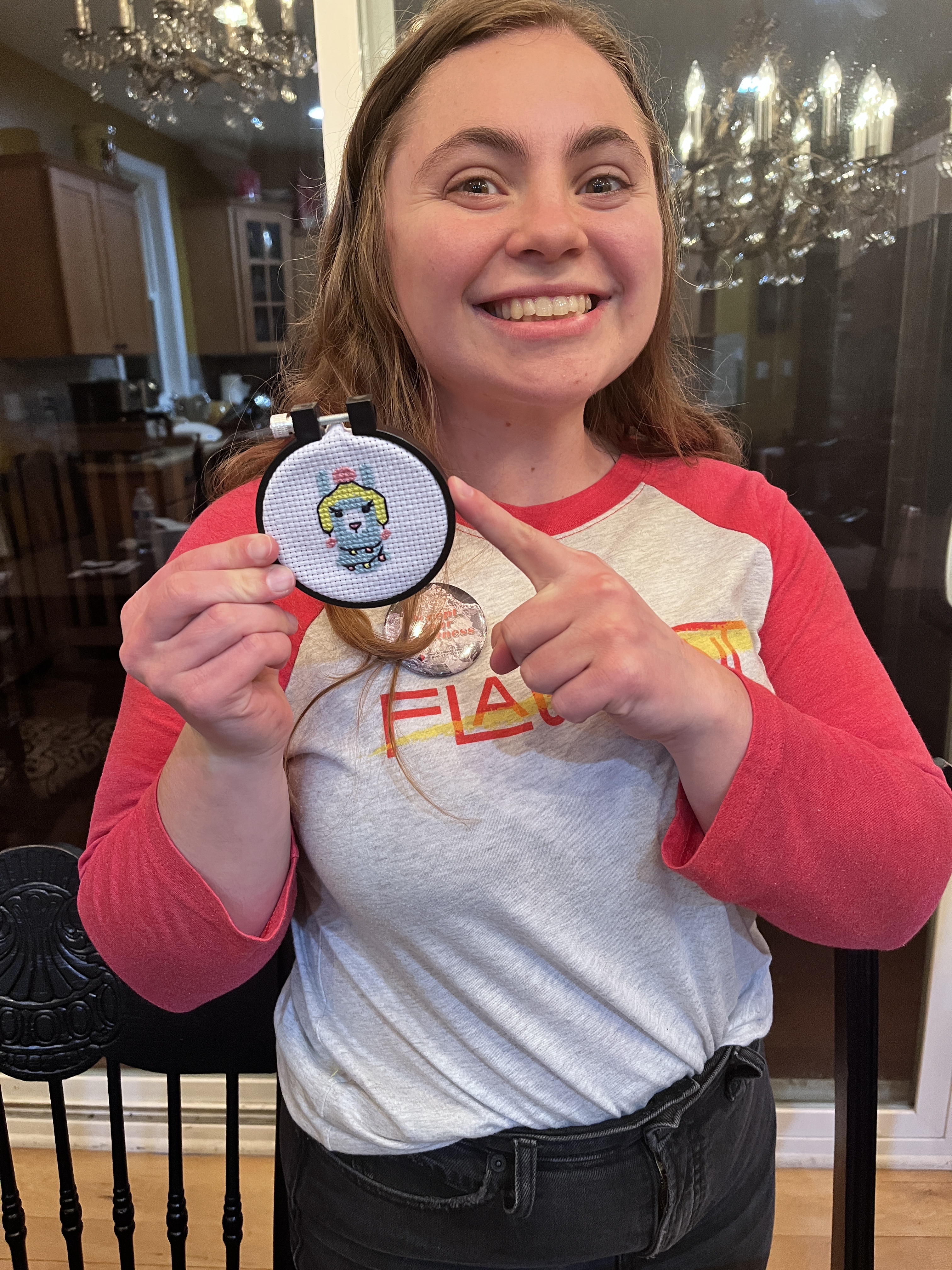 Kaylee taking pride in her cross-stitched llama